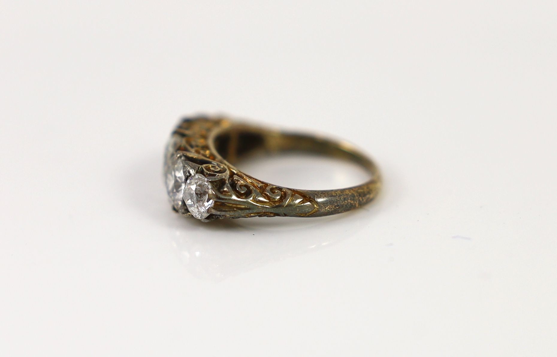 An early 20th century 18ct gold and graduated five stone diamond set half hoop ring